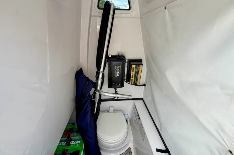 Slide: The Image of 2023 Sportsman Heritage 261 Center Console interior with toilet and storage area. - 54