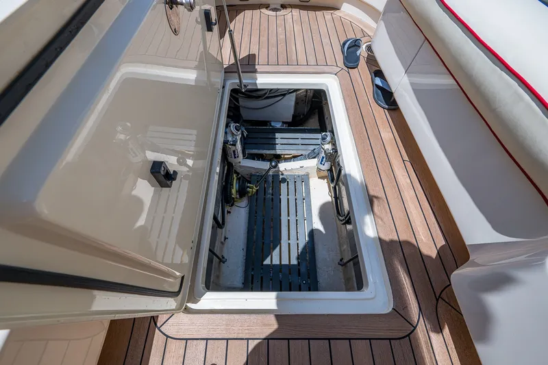 Slide: The Image of Open hatch on 2008 Hinckley Talaria 38R Convertible boat deck, revealing storage compartment. - 19