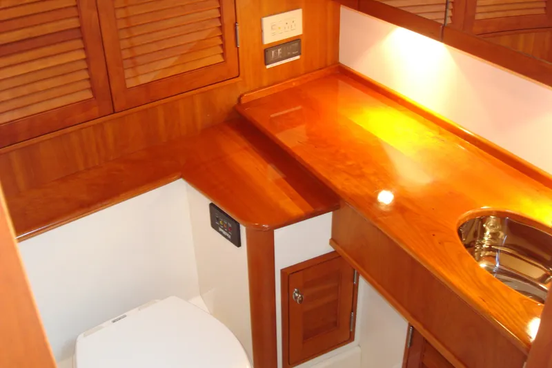 Slide: The Image of Luxurious wooden interior of 2008 Hinckley Talaria 38R Convertible yacht bathroom. - 7