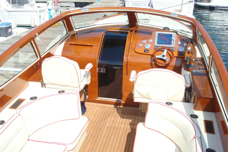 Slide: The Image of Luxurious 2008 Hinckley Talaria 38R Convertible yacht interior with elegant wood finish and modern navigation. - 5