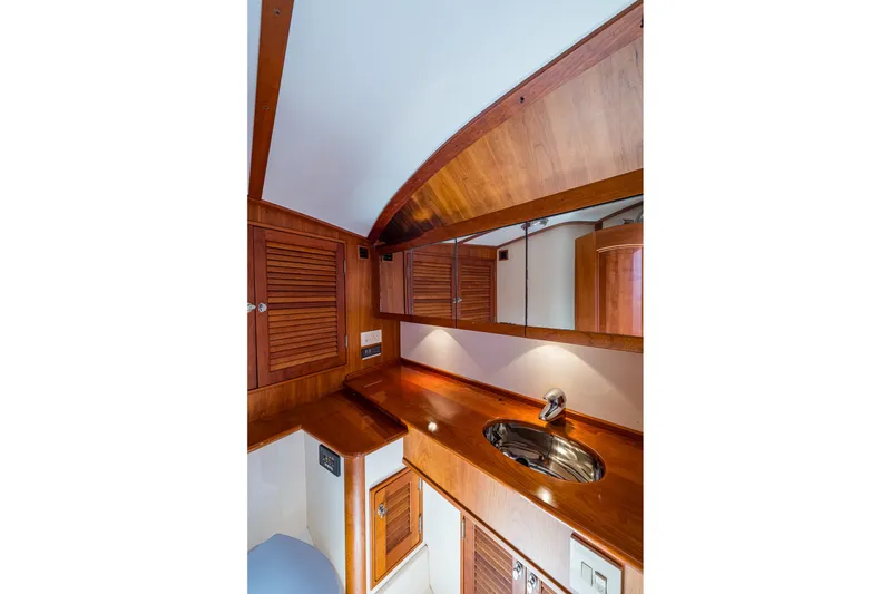 Slide: The Image of Luxurious wooden interior of 2008 Hinckley Talaria 38R Convertible yacht bathroom. - 15