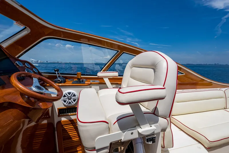 Slide: The Image of Luxurious 2008 Hinckley Talaria 38R Convertible yacht interior with leather seating and wooden helm. - 8