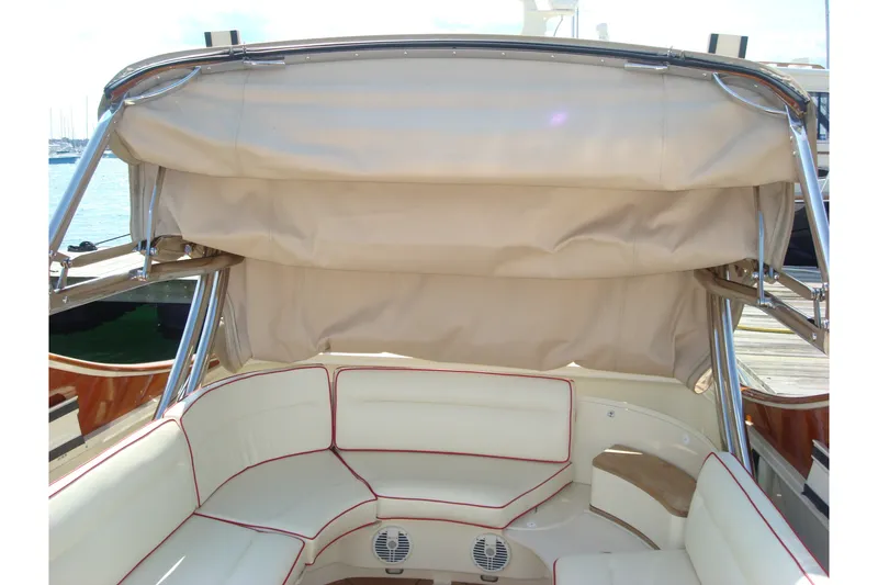 Slide: The Image of 2008 Hinckley Talaria 38R Convertible boat interior with beige seating and canopy. - 9