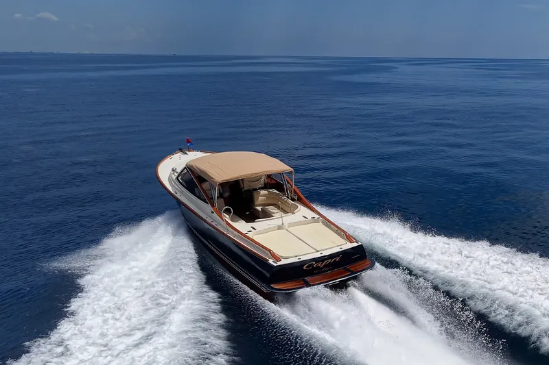 Slide: The Image of 2008 Hinckley Talaria 38R Convertible cruising on open water, rear view. - 2
