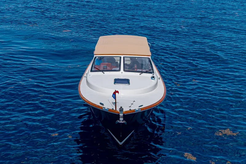 Slide: The Image of 2008 Hinckley Talaria 38R Convertible boat on blue ocean water. - 3