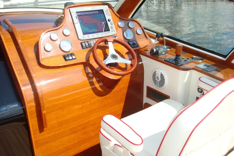 Slide: The Image of Helm of 2008 Hinckley Talaria 38R Convertible with wooden dashboard and navigation equipment. - 3