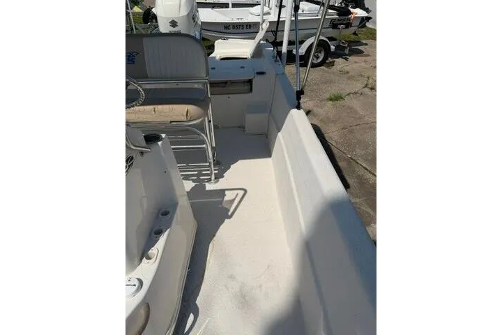Slide: The Image of 2017 Carolina Skiff 238 DLV boat interior with seating and storage compartments. - 14