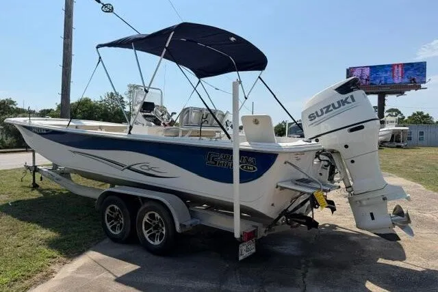 Slide: The Image of 2017 Carolina Skiff 238 DLV boat with Suzuki outboard motor on trailer. - 2