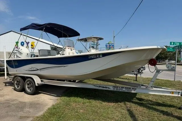Slide: The Image of 2017 Carolina Skiff 238 DLV boat on trailer, parked outdoors under clear sky. - 1