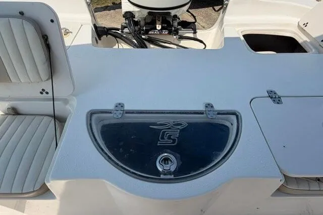 Slide: The Image of 2017 Carolina Skiff 238 DLV boat interior with seating and storage compartments. - 19