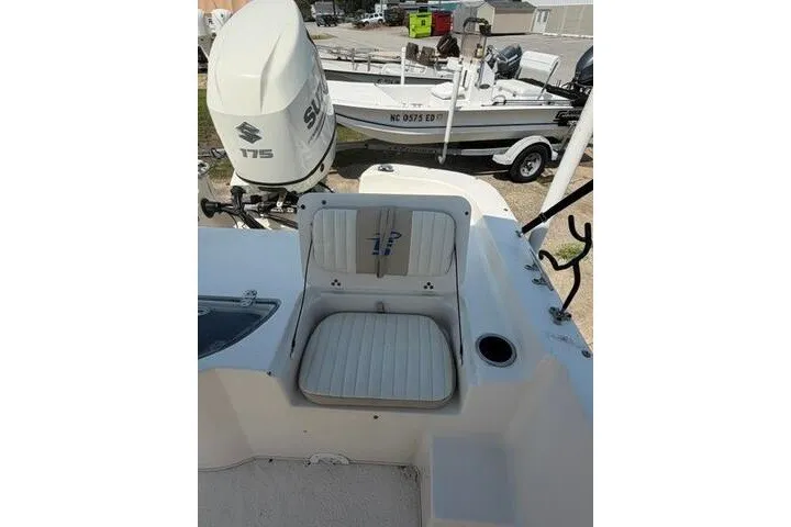 Slide: The Image of 2017 Carolina Skiff 238 DLV boat with Suzuki engine, featuring seating and storage area. - 21