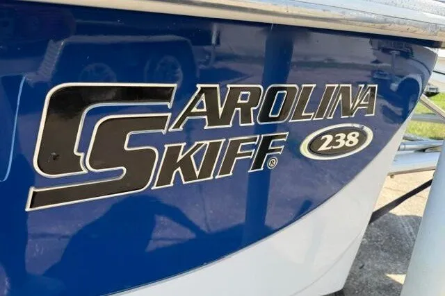 Slide: The Image of 2017 Carolina Skiff 238 DLV boat logo on blue hull. - 10