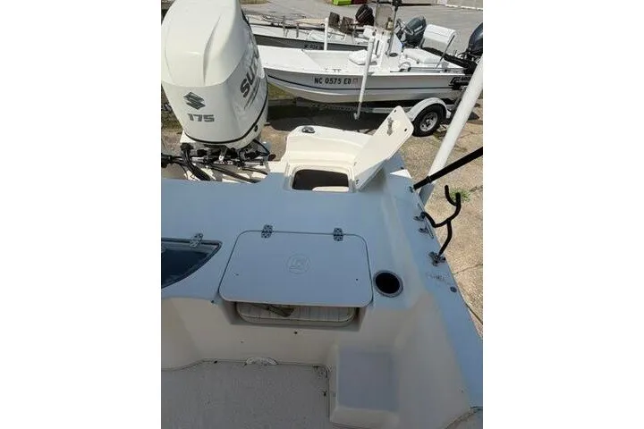 Slide: The Image of 2017 Carolina Skiff 238 DLV boat with Suzuki 175 engine, docked outdoors. - 20