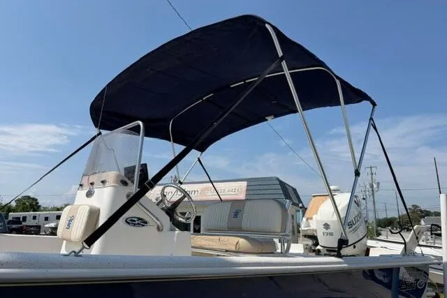 Slide: The Image of 2017 Carolina Skiff 238 DLV boat with canopy and Suzuki outboard motor. - 8