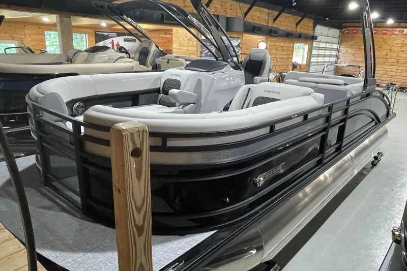 Slide: The Image of 2027 Harris Solstice 230 SL pontoon boat in showroom, featuring sleek design and comfortable seating. - 14