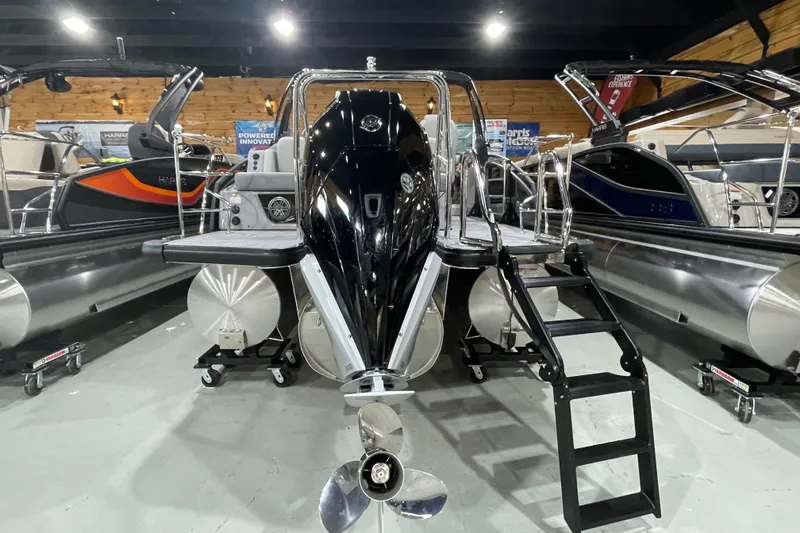 Slide: The Image of 2027 Harris Solstice 230 SL pontoon boat displayed in showroom with sleek design and modern features. - 21