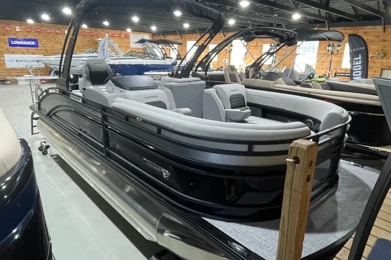 Slide: The Image of 2027 Harris Solstice 230 SL pontoon boat displayed in a showroom. - 18