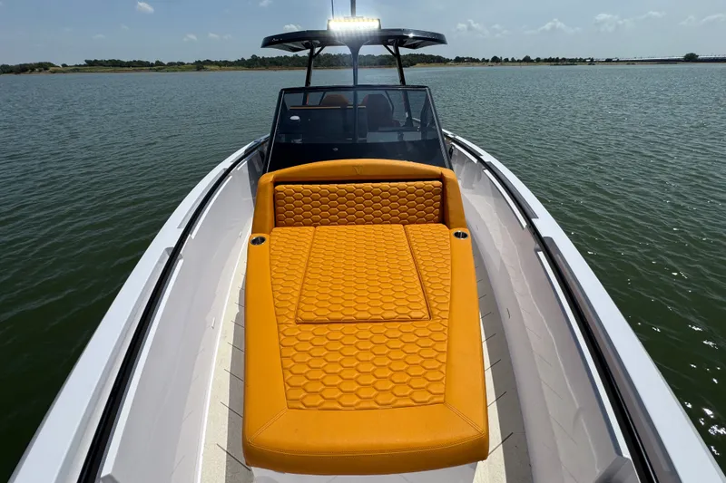 Slide: The Image of Luxurious 2026 VIRTUE YACHTS V33 Top with vibrant orange seating on calm waters. - 16