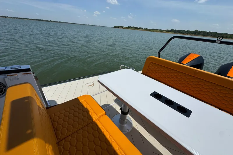 Slide: The Image of Luxury VIRTUE YACHTS V33 Top 2026 with orange seating, overlooking serene waters. - 32