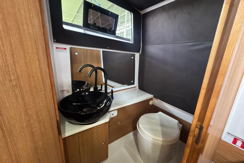 Slide: The Image of Luxurious bathroom in 2026 VIRTUE YACHTS V33 Top with modern black sink and toilet. - 10