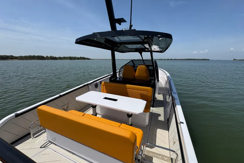 Slide: The Image of 2026 VIRTUE YACHTS V33 Top on serene water, featuring sleek design and vibrant seating. - 30