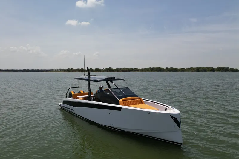 Slide: The Image of The boat is a modern model with a sleek white hull and orange seating. - 7