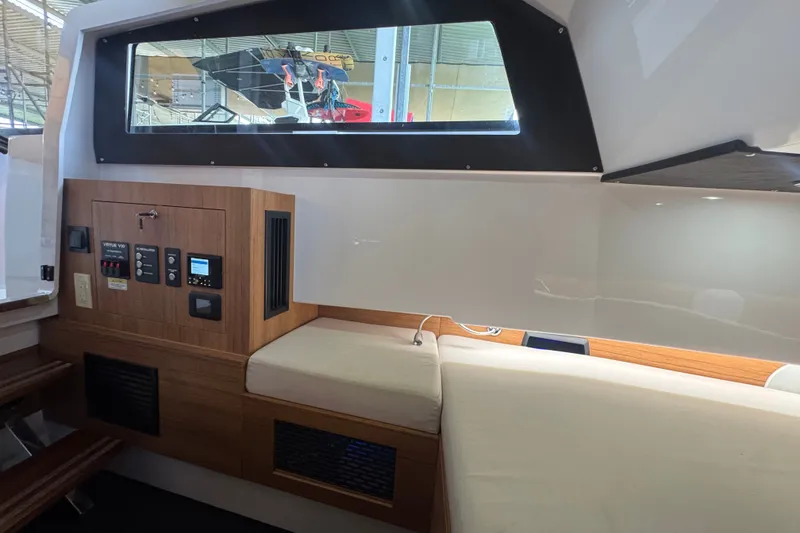 Slide: The Image of Interior of 2026 VIRTUE YACHTS V33 Top, featuring modern control panel and seating. - 9