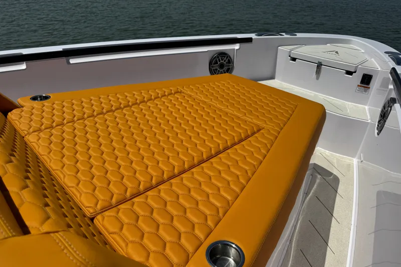 Slide: The Image of Luxurious orange seating on 2026 VIRTUE YACHTS V33 Top, featuring hexagonal stitching. - 12