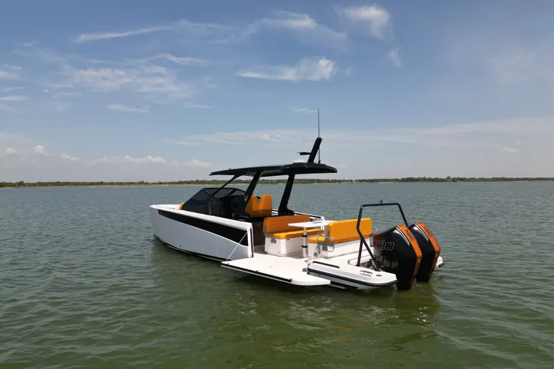 Slide: The Image of Modern 2026 VIRTUE YACHTS V33 Top on serene water, featuring sleek design and vibrant seating. - 2