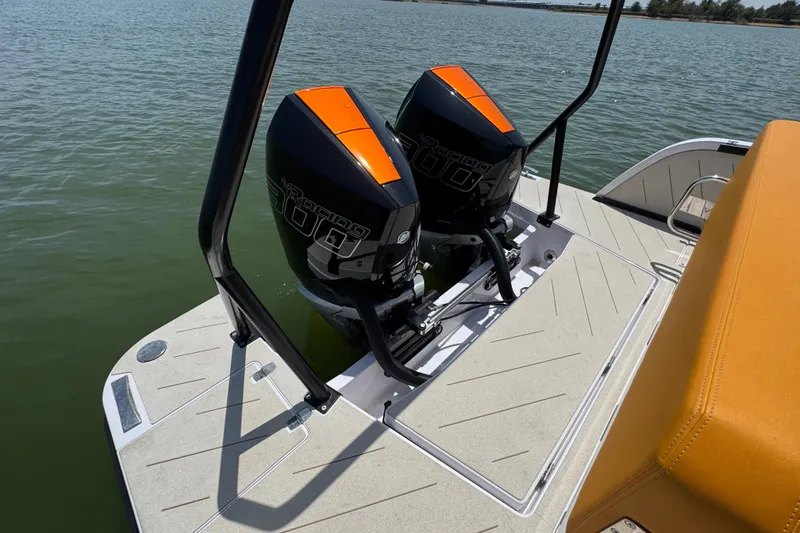 Slide: The Image of Twin outboard engines on 2026 VIRTUE YACHTS V33 Top, docked on calm water. - 29