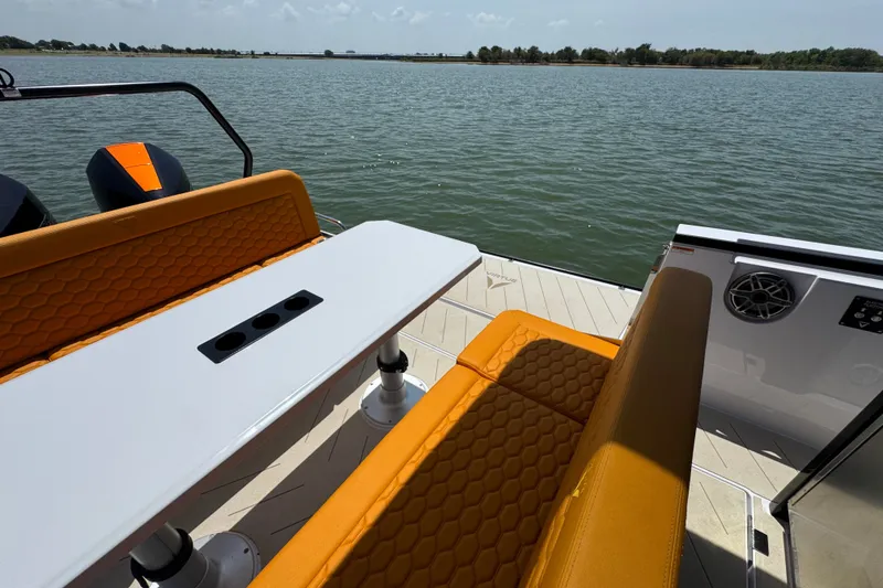 Slide: The Image of Luxury VIRTUE YACHTS V33 Top 2026 with orange seating, table, and scenic water view. - 31