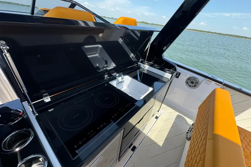 Slide: The Image of Modern kitchen area on 2026 VIRTUE YACHTS V33 Top, featuring sleek design and lake view. - 27
