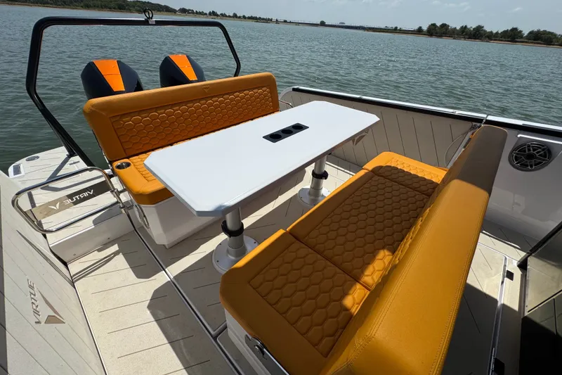 Slide: The Image of Luxury seating area on 2026 VIRTUE YACHTS V33 Top, featuring orange upholstery and a white table. - 28