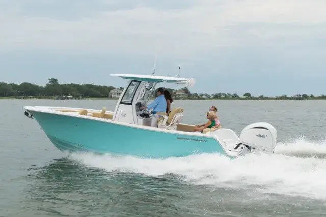 The Image of 2027 Sportsman Heritage 231 Center Console boat cruising on water with passengers. - 1