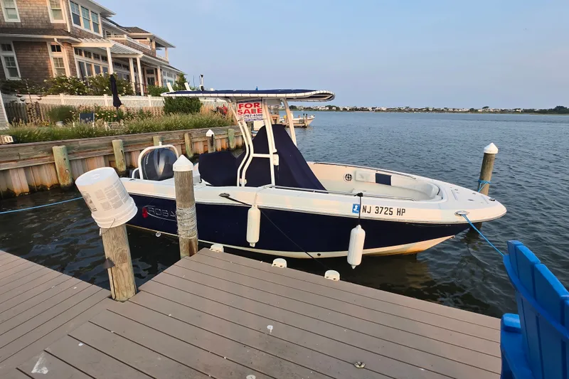 Slide: The Image of 2021 Robalo R200 Center Console boat docked, for sale, near waterfront homes. - 14