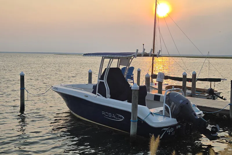 The Image of 2021 Robalo R200 Center Console boat docked at sunset on calm waters. - 0