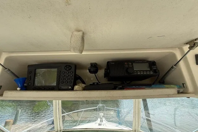 Slide: The Image of 1998 Pursuit 3000 Offshore boat dashboard with navigation and communication equipment. - 14