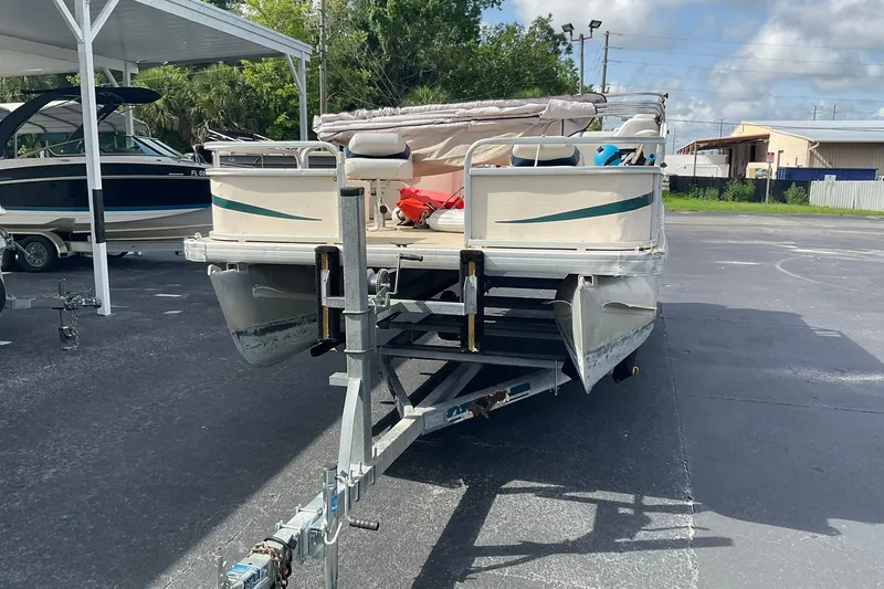Slide: The Image of 2004 Sweetwater Challenger 200 FC pontoon boat on trailer in parking lot. - 1