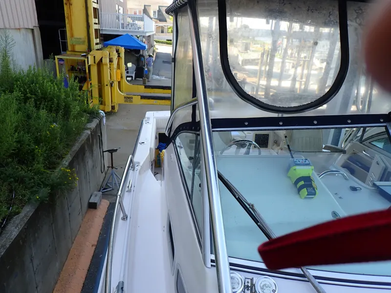 Slide: The Image of The image shows the deck of a 2003 Grady-White Gulfstream 232S with a clear cover. - 14