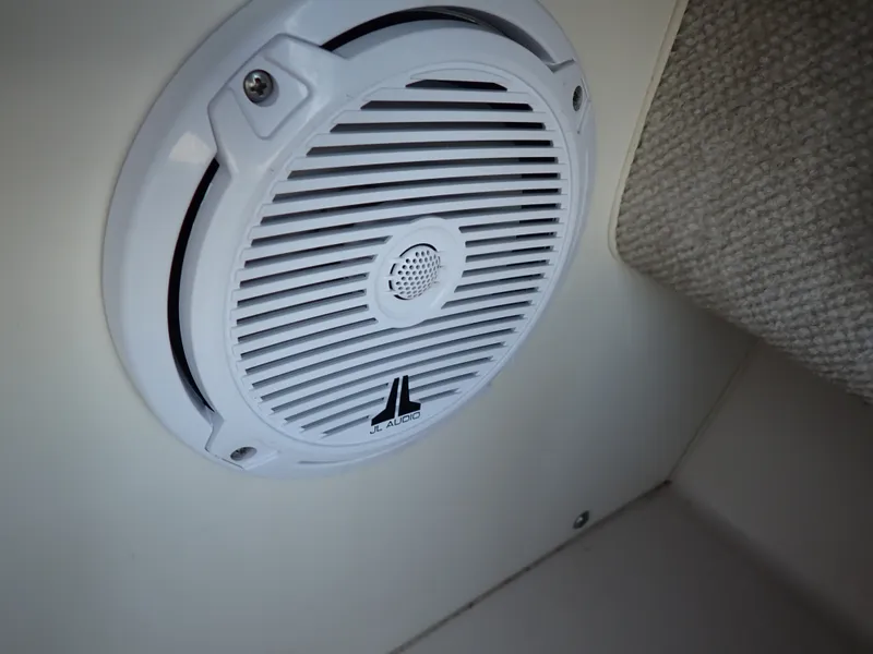 Slide: The Image of A white JL Audio speaker is mounted on the wall of a boat. - 20