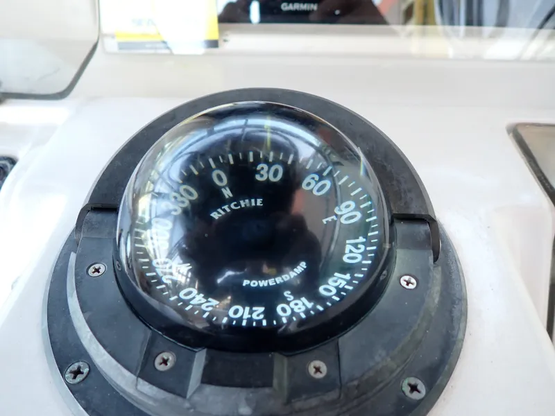 Slide: The Image of A compass on a boat, displaying cardinal directions and degrees. - 21