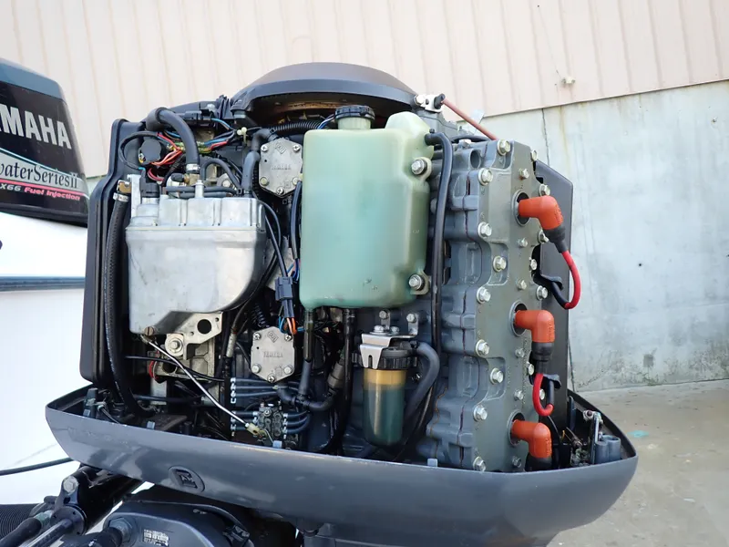 Slide: The Image of A Yamaha outboard motor with exposed components, mounted on a boat. - 16