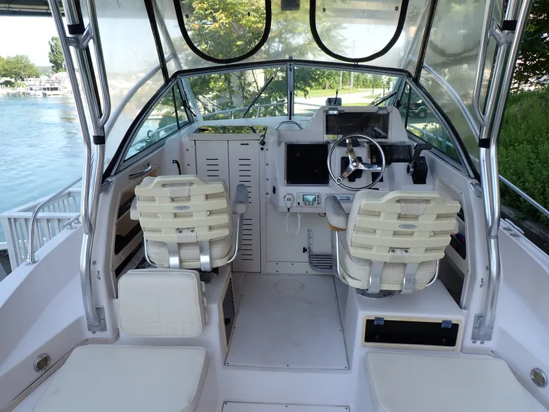 Slide: The Image of The image shows the cockpit of a 2003 Grady-White Gulfstream 232S with two seats and a helm. - 24