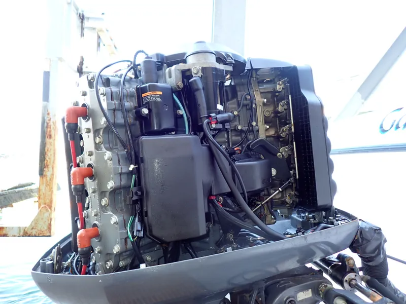 Slide: The Image of An outboard motor with exposed components and wiring, mounted on a boat. - 17