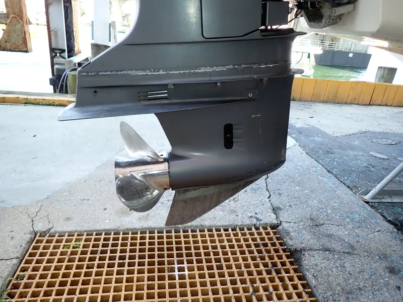 Slide: The Image of Close-up of a boat motor with propeller, standing on a grated surface. - 28