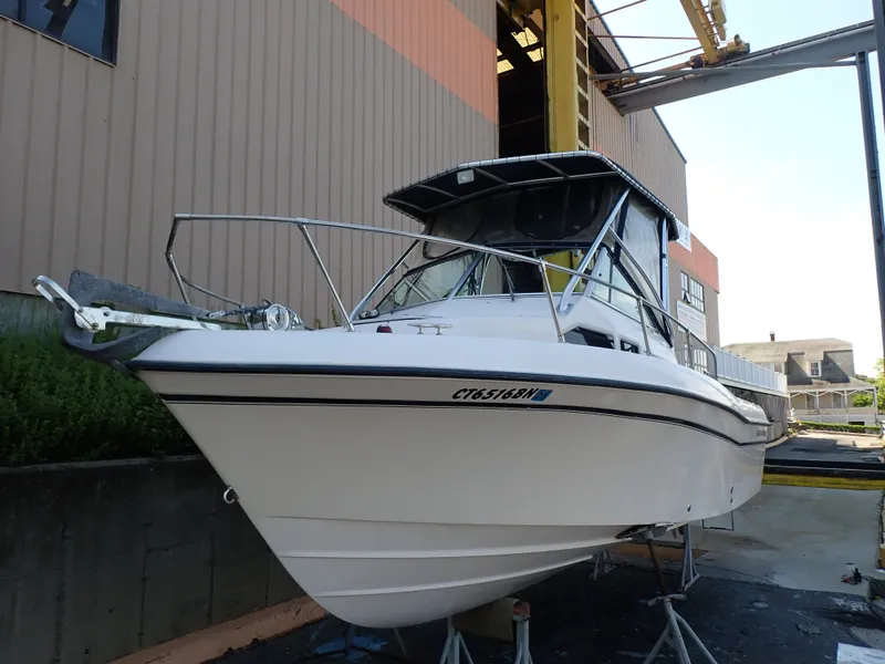 The Image of A 2003 Grady-White Gulfstream 232S boat is on stands in a shipyard area. - 0
