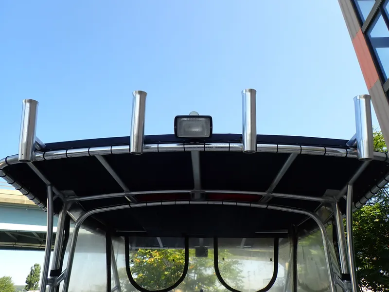 Slide: The Image of The image shows the roof of a Grady-White Gulfstream 232S boat with fishing rod holders. - 25