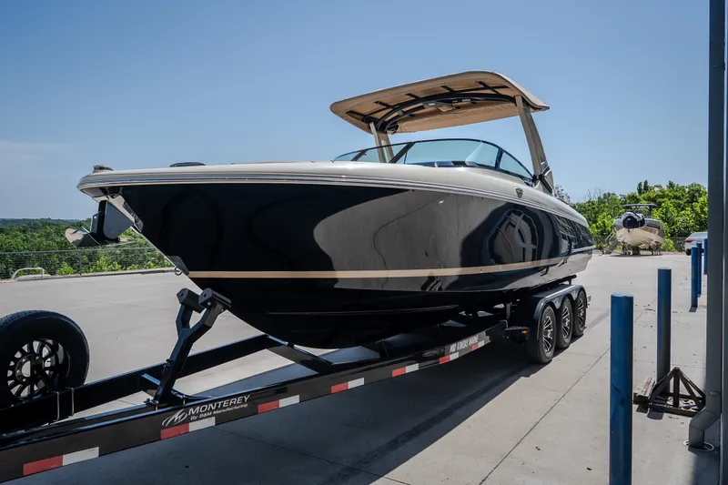 Slide: The Image of 2026 Chris-Craft Sportster 28 boat on trailer, parked outdoors under clear sky. - 4
