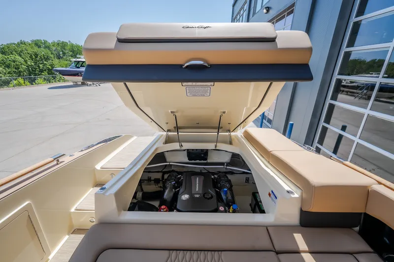 Slide: The Image of 2026 Chris-Craft Sportster 28 boat engine compartment, open hatch, modern design. - 19