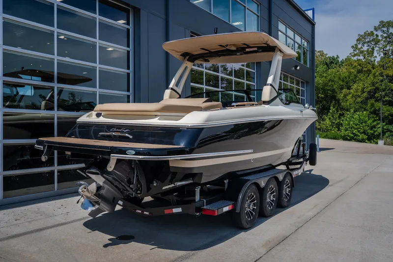 Slide: The Image of 2026 Chris-Craft Sportster 28 boat on trailer, parked outside modern building. - 5